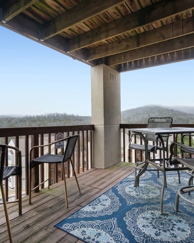 Covered balcony with misty Ozark mountain views in Branson