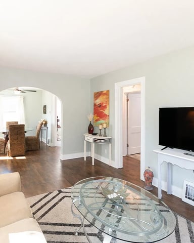 Bright living room with hardwood floors at the Golf Course Cottage